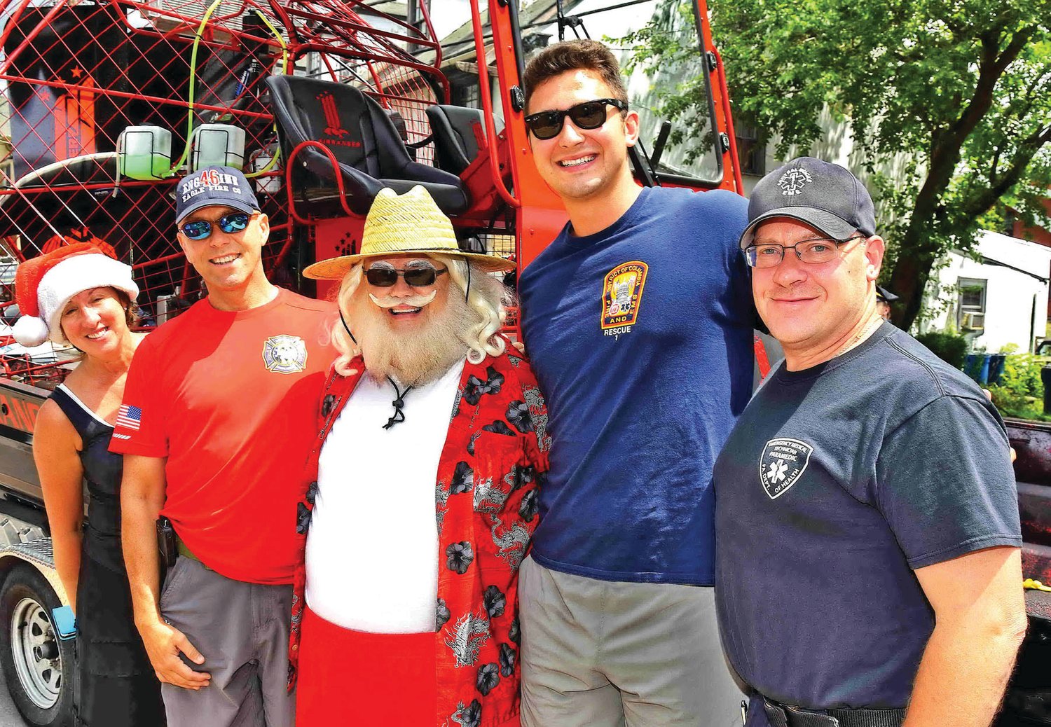 Cindy Hall, executive director of the New Hope Historical Society, with members of the Eagle Fire Co. and Rescue Squad and Santa (in summer attire).