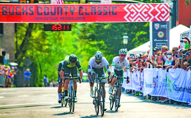 The Bucks County Classic top three winners glide past the finish line Sunday afternoon after looping Doylestown streets.