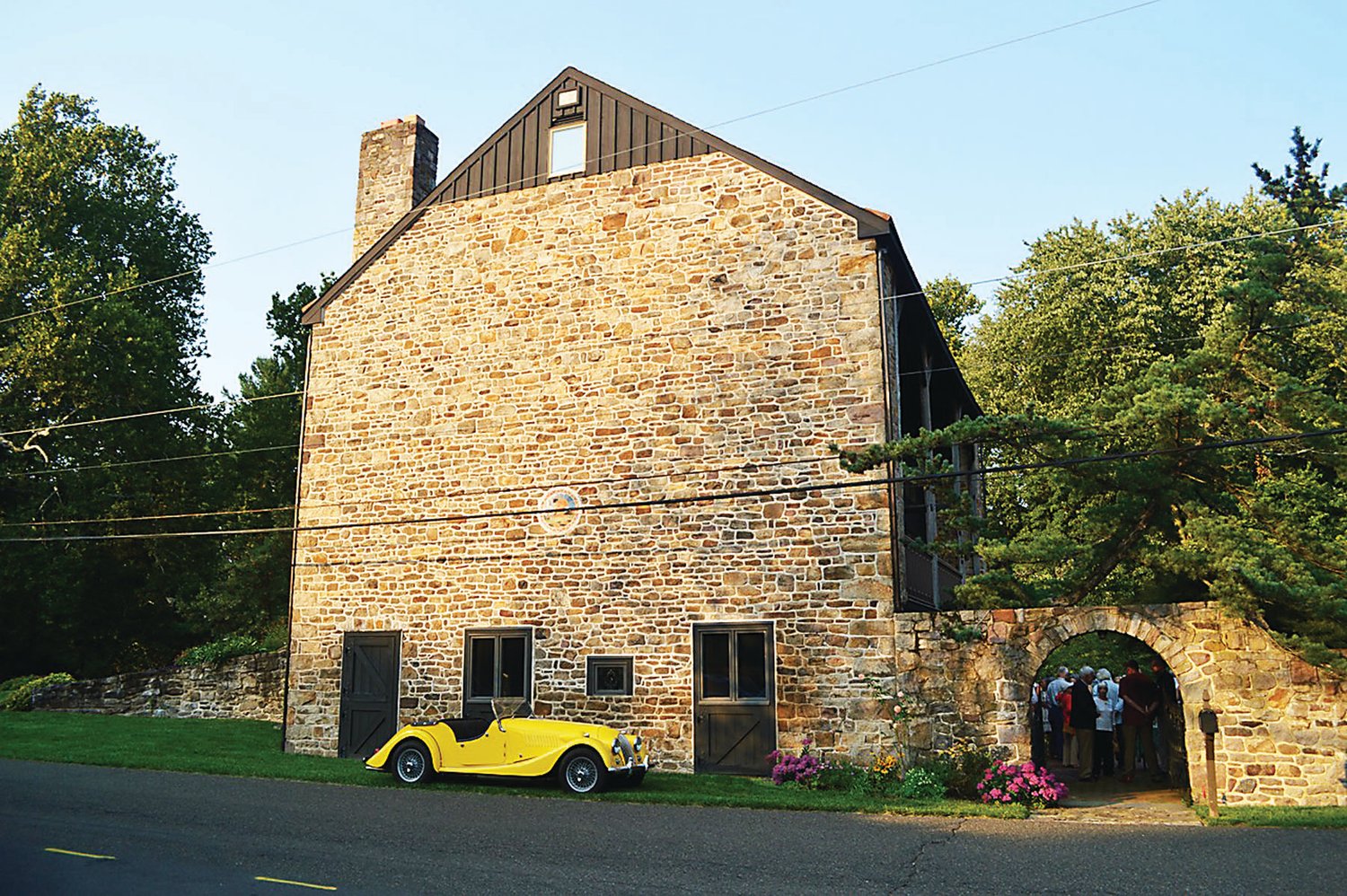 The Fowles residence, a converted barn. Guests gathered inside the courtyard.
