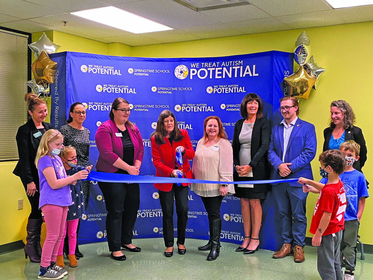 Government officials and members of the Central and Lower Bucks Chambers of Commerce joined Potential staff members in cutting the ribbon and opening its new Warminster center. From left are: Lower Bucks Chamber of Commerce representative Anna Bogiatzis, state Rep. Meghan Schroeder, Potential Donor Relationship Manager Hillary Sawyer, Central Bucks Chamber of Commerce representative Deborah Wagner, Potential founder, President and CEO Kristine Quinby, state Rep. Wendi Thomas, Kevin Bongarzone on behalf of U.S. Rep. Brian Fitzpatrick, and Donna Elms on behalf of state Sen. Maria Collett. Holding the ribbon are some  little helpers in attendance.