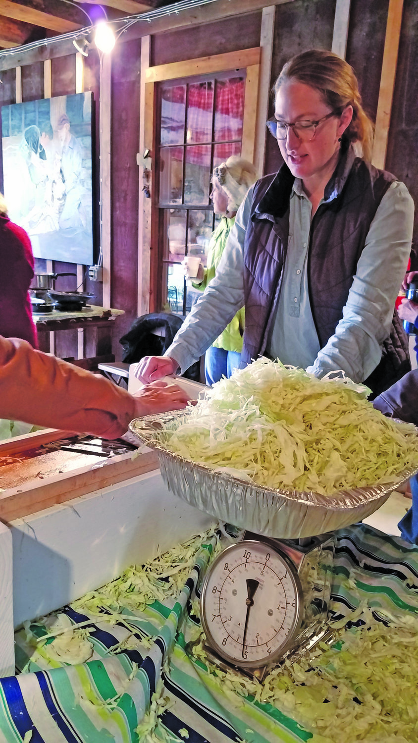 Amanda Penecale helps grate piles of cabbage to make into sauerkraut at the Plumsteadville Grange.