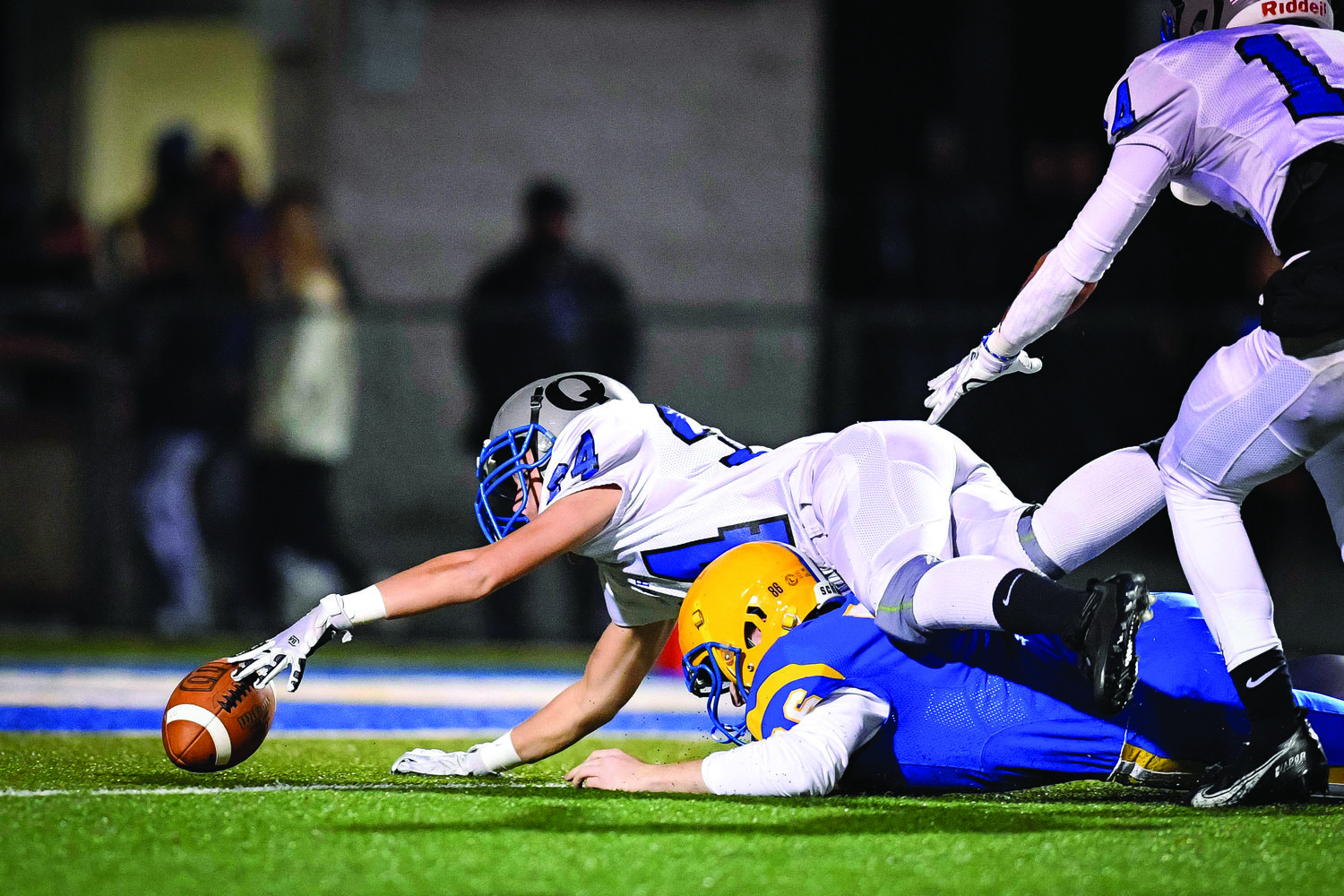 Quakertown’s Paul Lancos reaches for the ball at the goal line after blocking a Downingtown East punt.