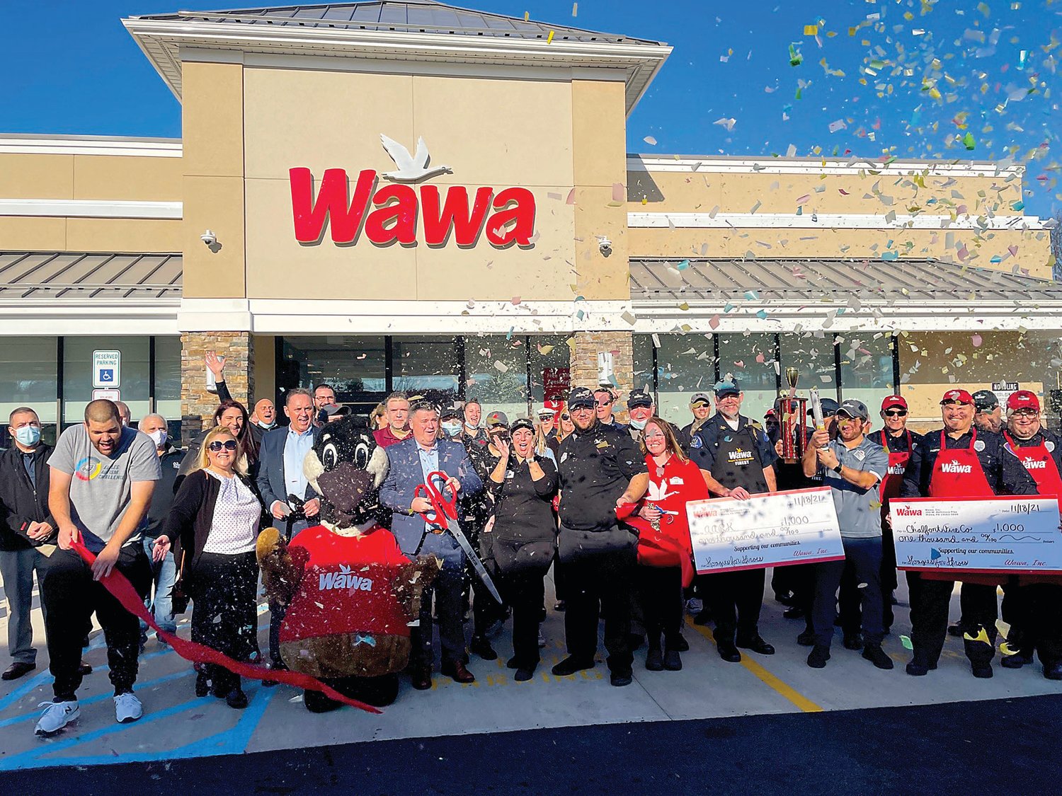 Tom Post, general manager of the new store, cuts the ribbon at the Chalfont Wawa.