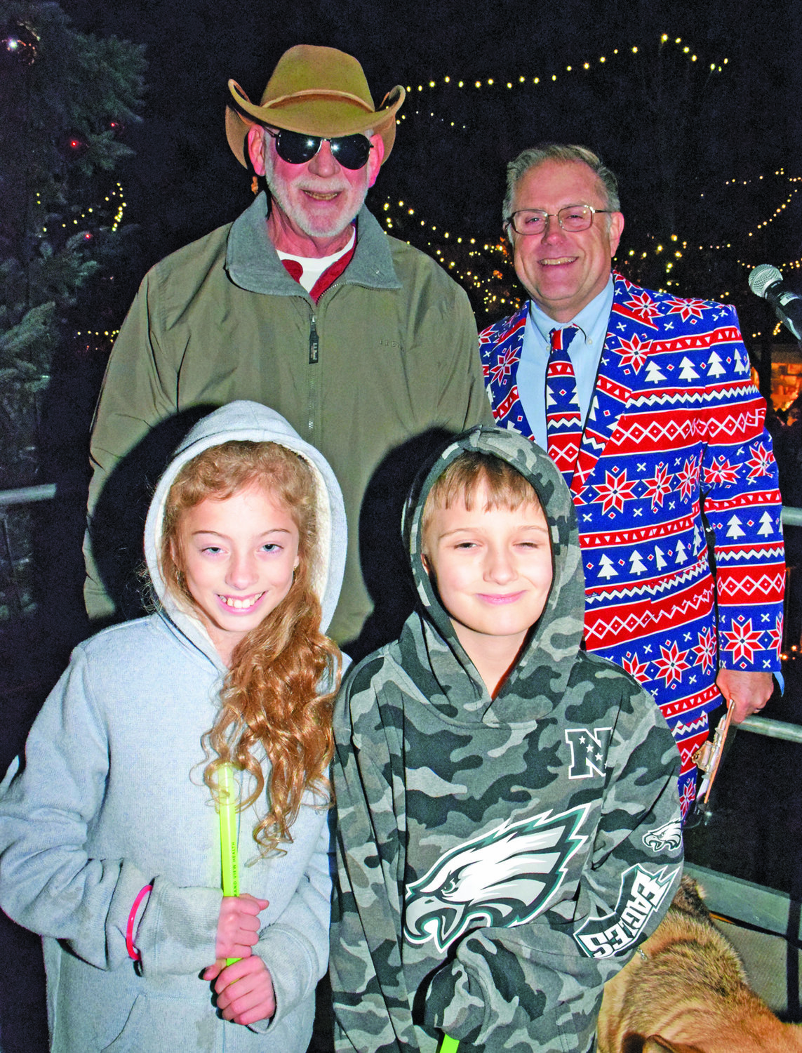 Perkasie Mayor John Hollenbach, Todd Hurley, executive vice president, chief relationship officer, Penn Community Bank, and Liam Nicolosi, 9, who won the chance to light the tree with Santa. He was assisted by his cousin Maria Ciuchta, 10.