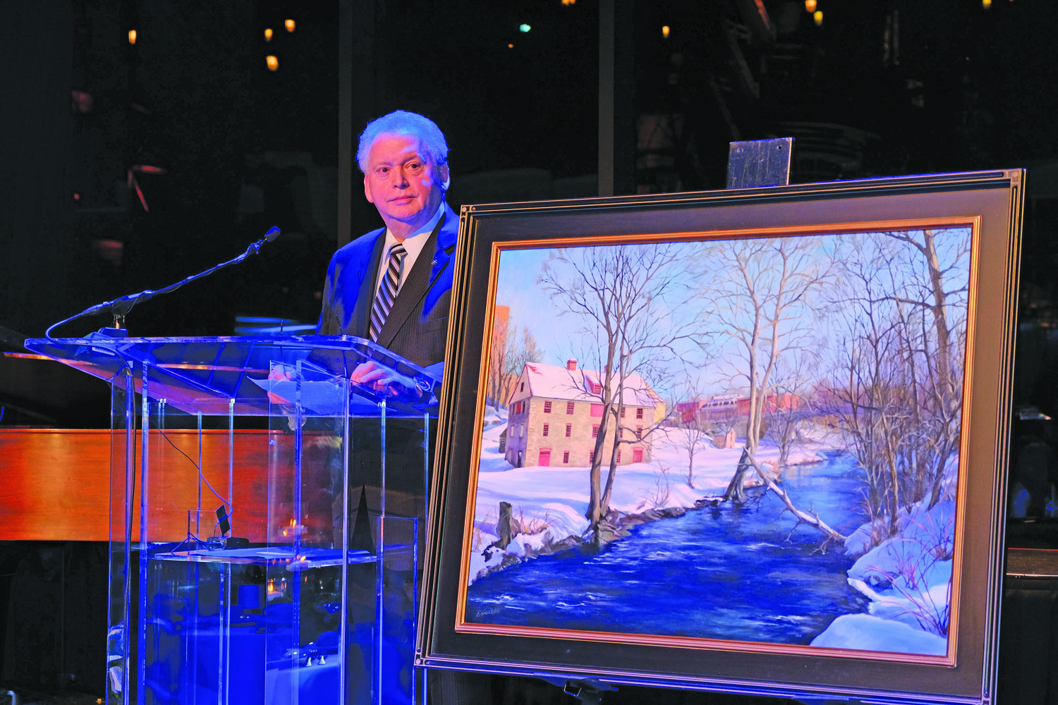 Joel C. Rosenfeld, chair with featured painting “Colonial Quarter Evening Shadows” by Elena Shackleton.