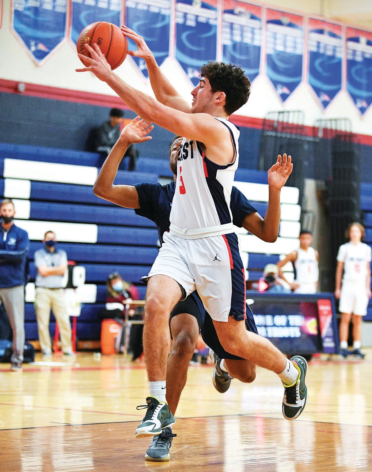CB East’s Nick Rivera drives the lane and dishes off a pass in front of North Penn’s Joe Larkins.