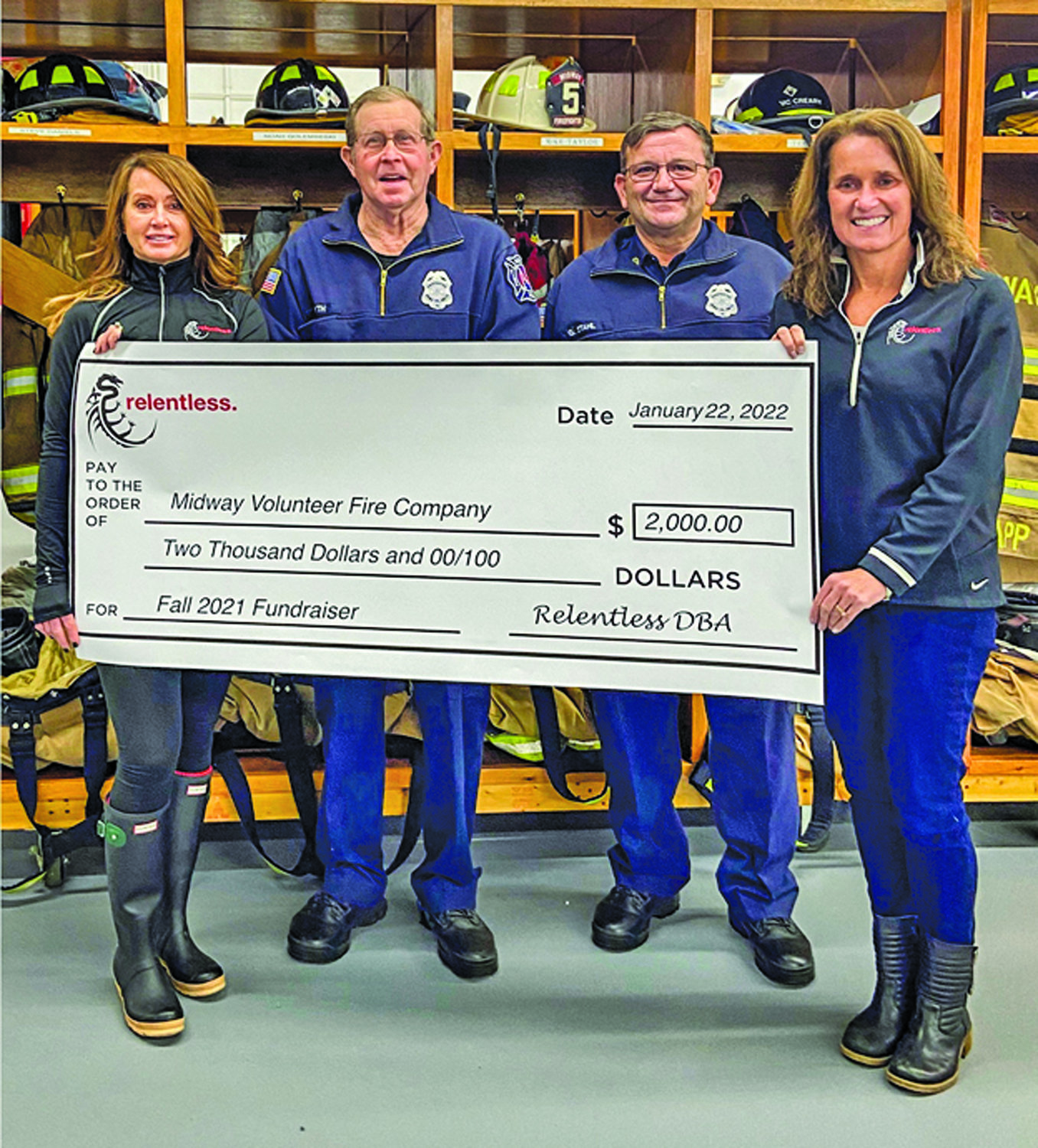 Presenting the donation check were Stephanie Leister of the Paddlers Fund Raising Committee, left, and Heather Sullivan, Relentless president. Receiving the donation for Midway were Lee Forsyth, president, left, and George Stahl, chief.