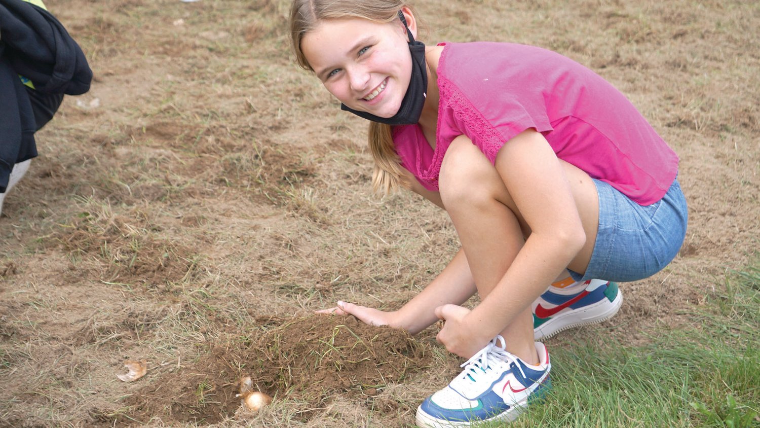 A student at Kutz Elementary School plants daffodil bulbs in memory of Dominic Liples.