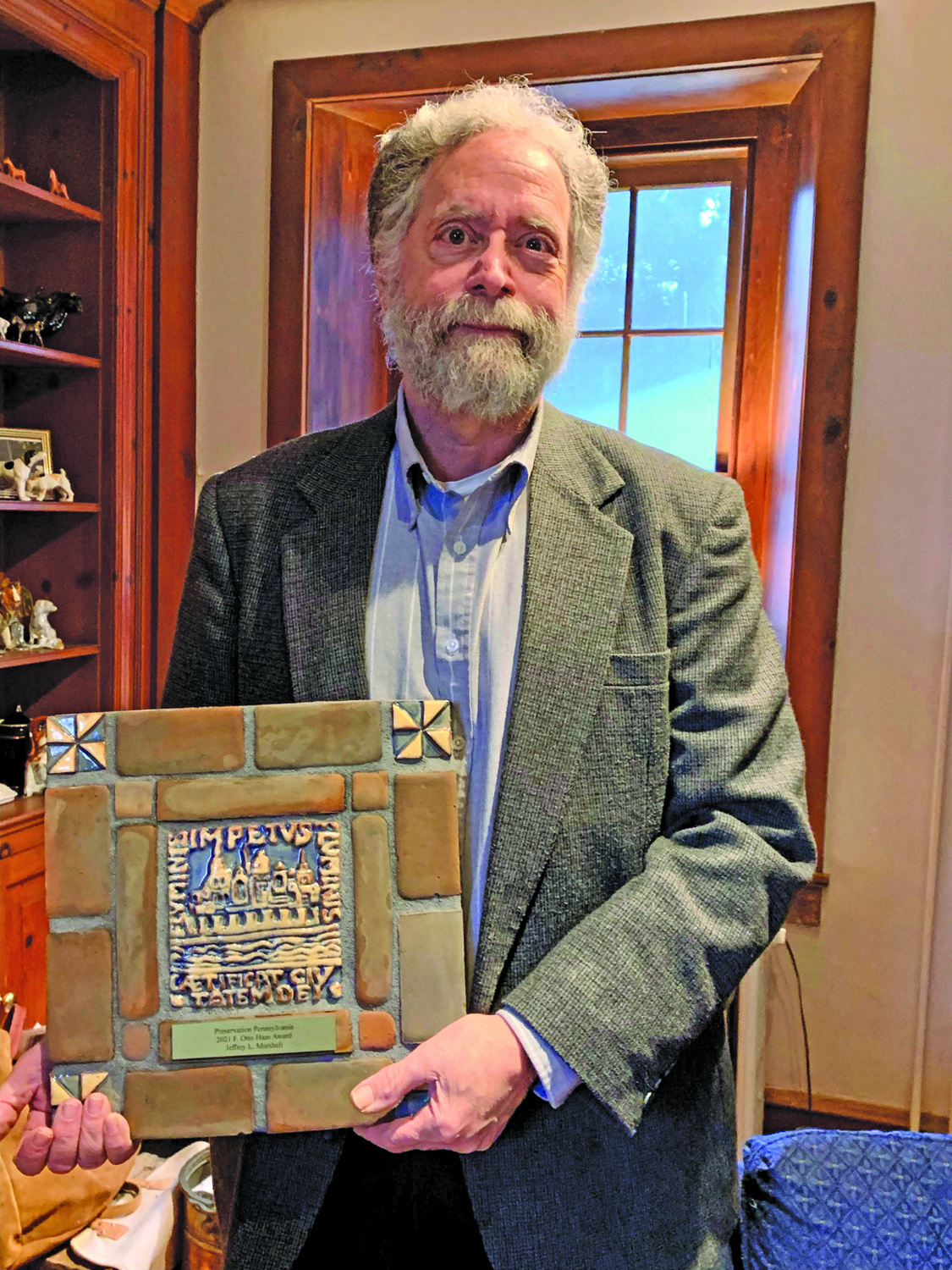 Jeffrey Marshall holds the F. Otto Haas Award, which he received from Preservation Pennsylvania.