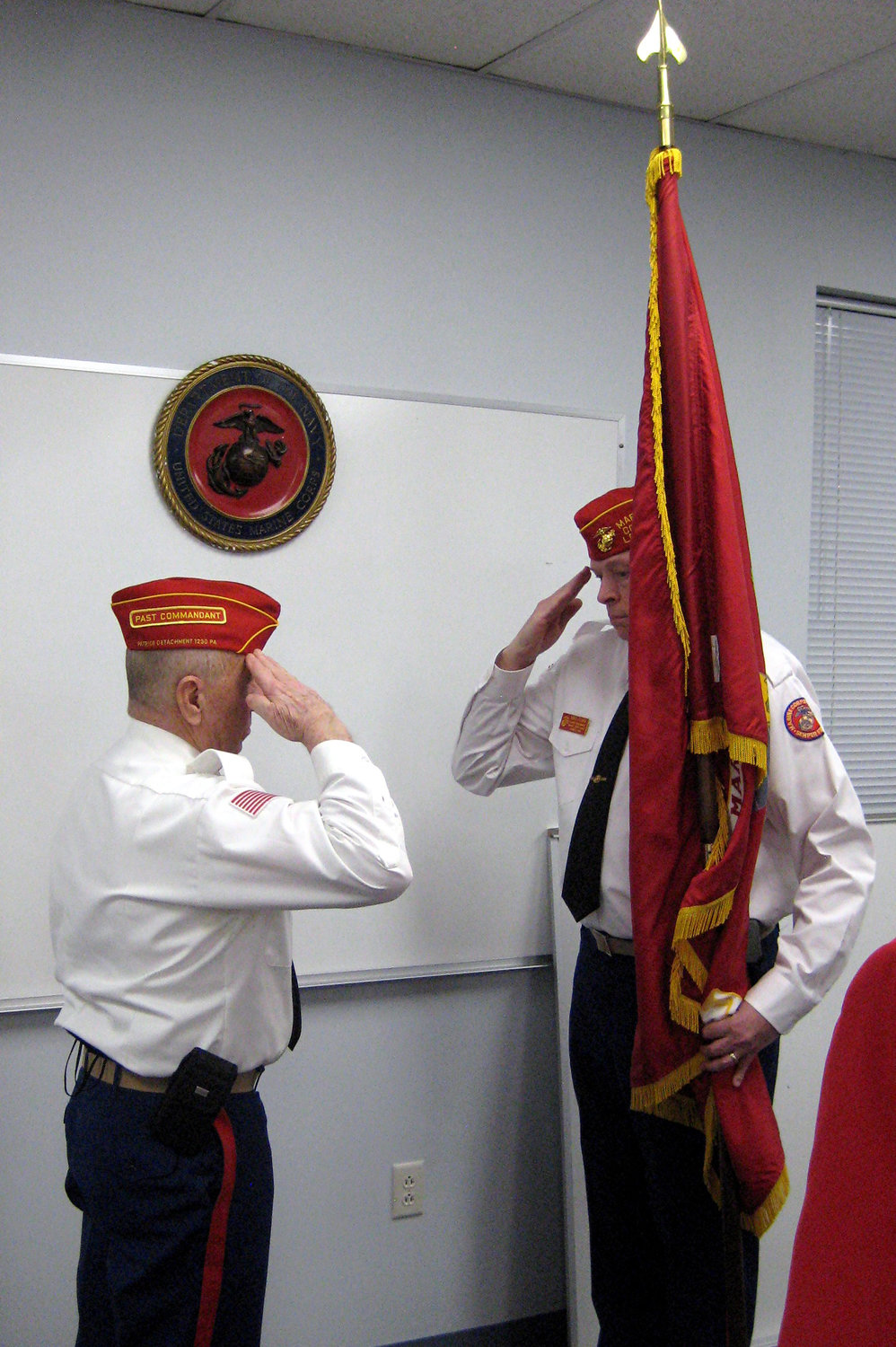 Neil Clark Sr., left, passes a Marine flag and command to new Commandant Mike Clark.
