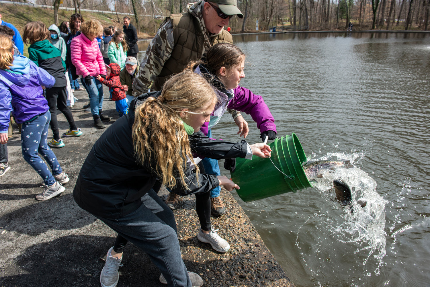 Students release fish into the pond.