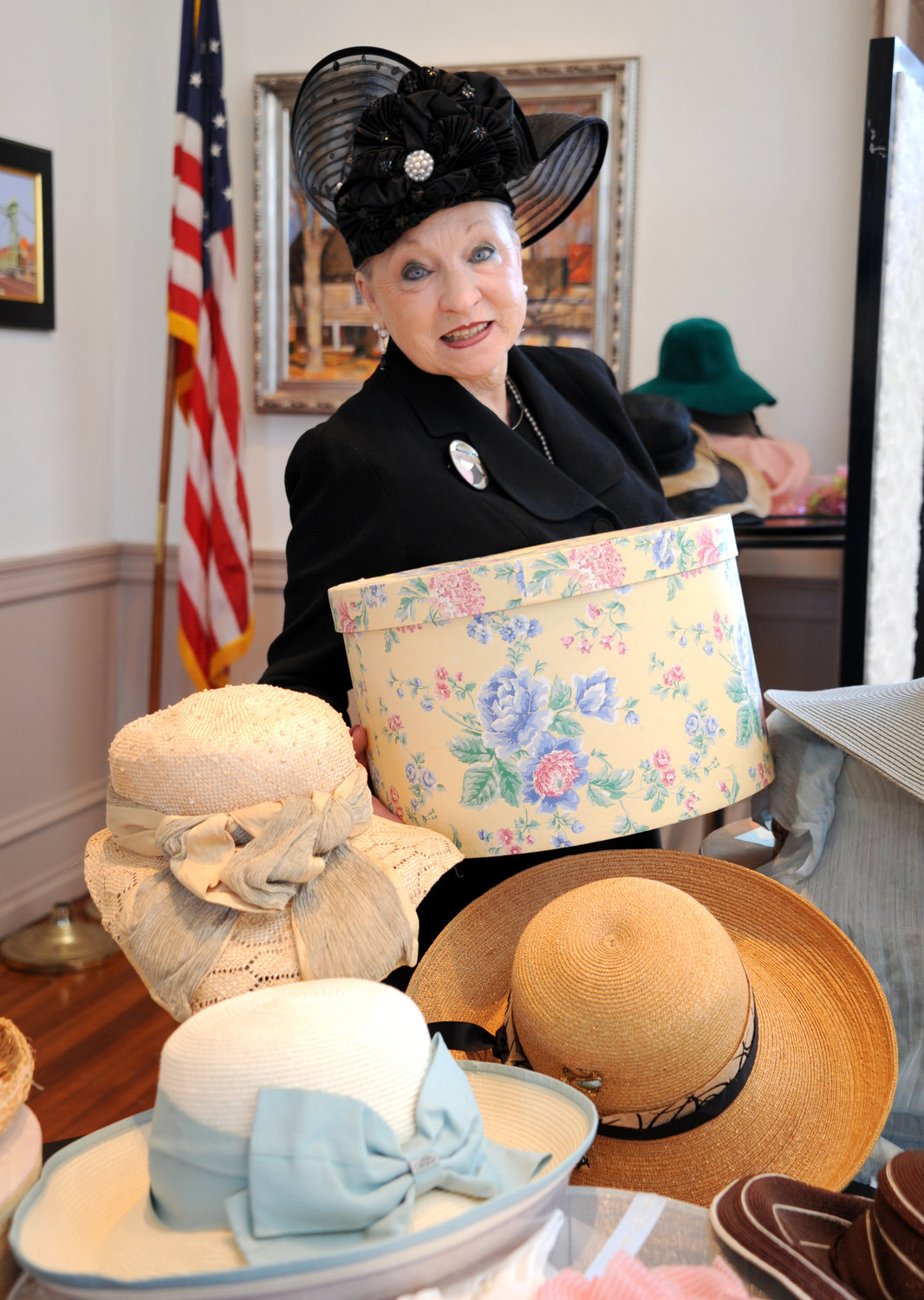 Lynne Anne Donchez stands amid her hat collection before she presented “The History of the 20th Century Through Hats” to the Bucks County Historical Society.