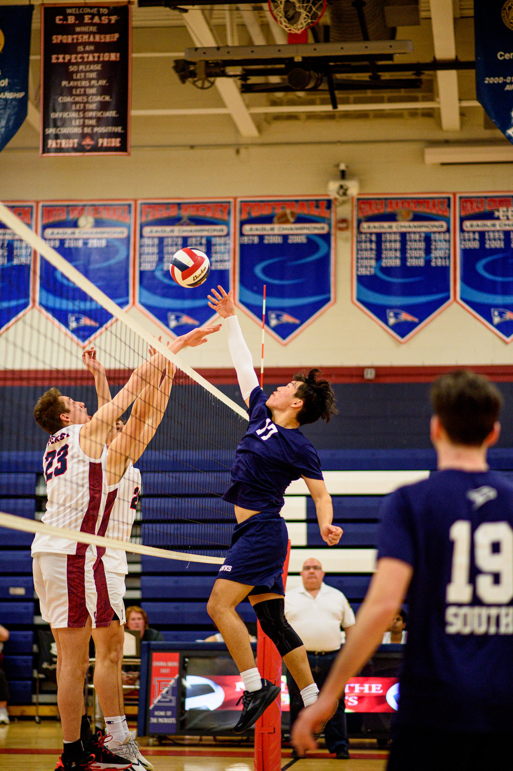 CR South’s Adil Abakirov reaches over the net.