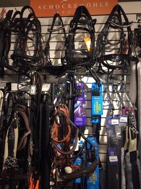 Colorful bridles from Germany cover a wall at Heidi Elwell’s Equine Earth store.