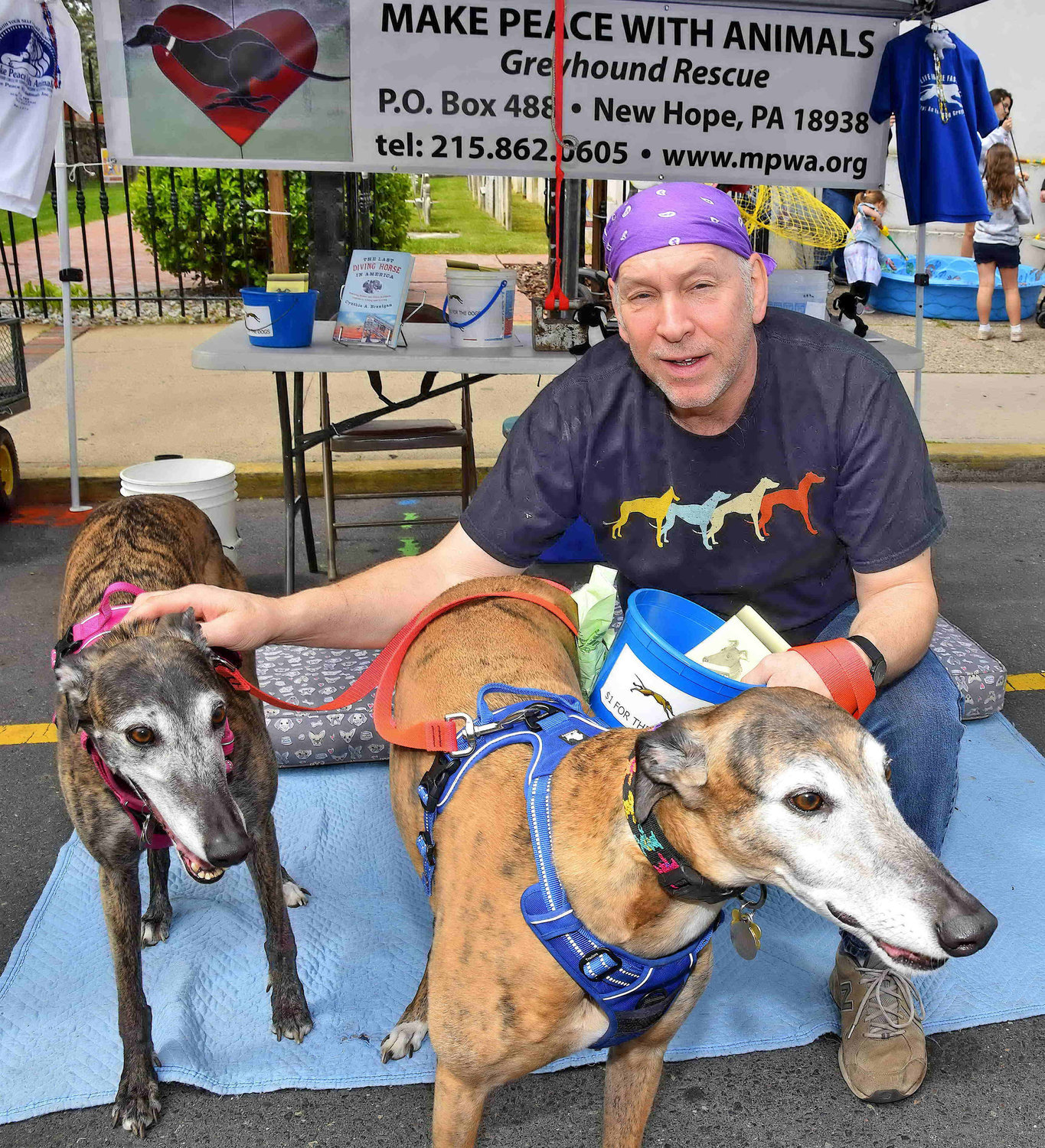 Jared Keller with greyhound rescues Timmy and Sara.