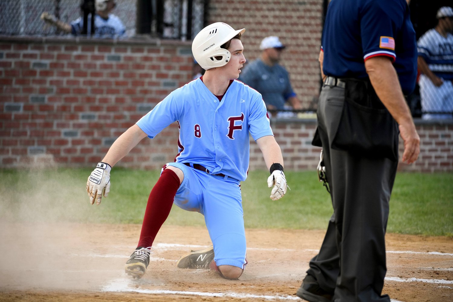 Faith’s Brendan Gallagher slides home with the Lions first run of the game in the second inning.