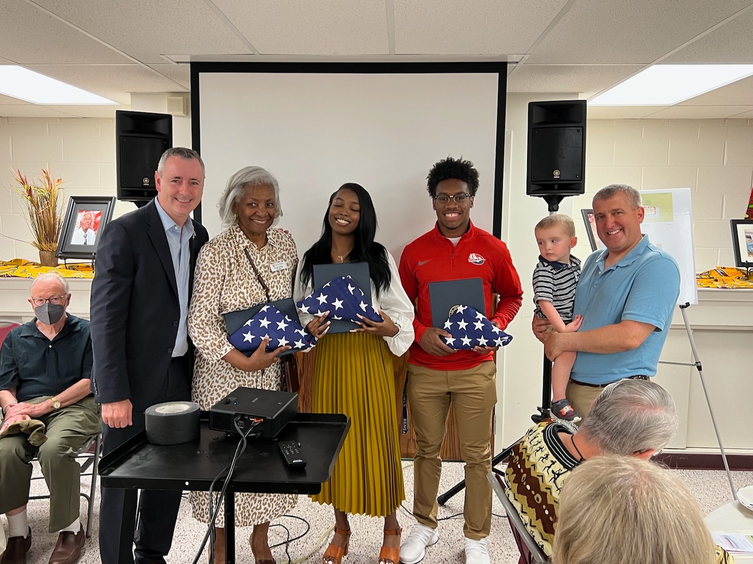 U.S. Rep. Brian Fitzpatrick, Linda Salley, scholarship winners Clarissa Gabriel and Josiah Leonard, and state Rep. Frank Farry with his grandson. Fitzpatrick said that he and Farry grew up in Middletown Township, where the new museum is located.