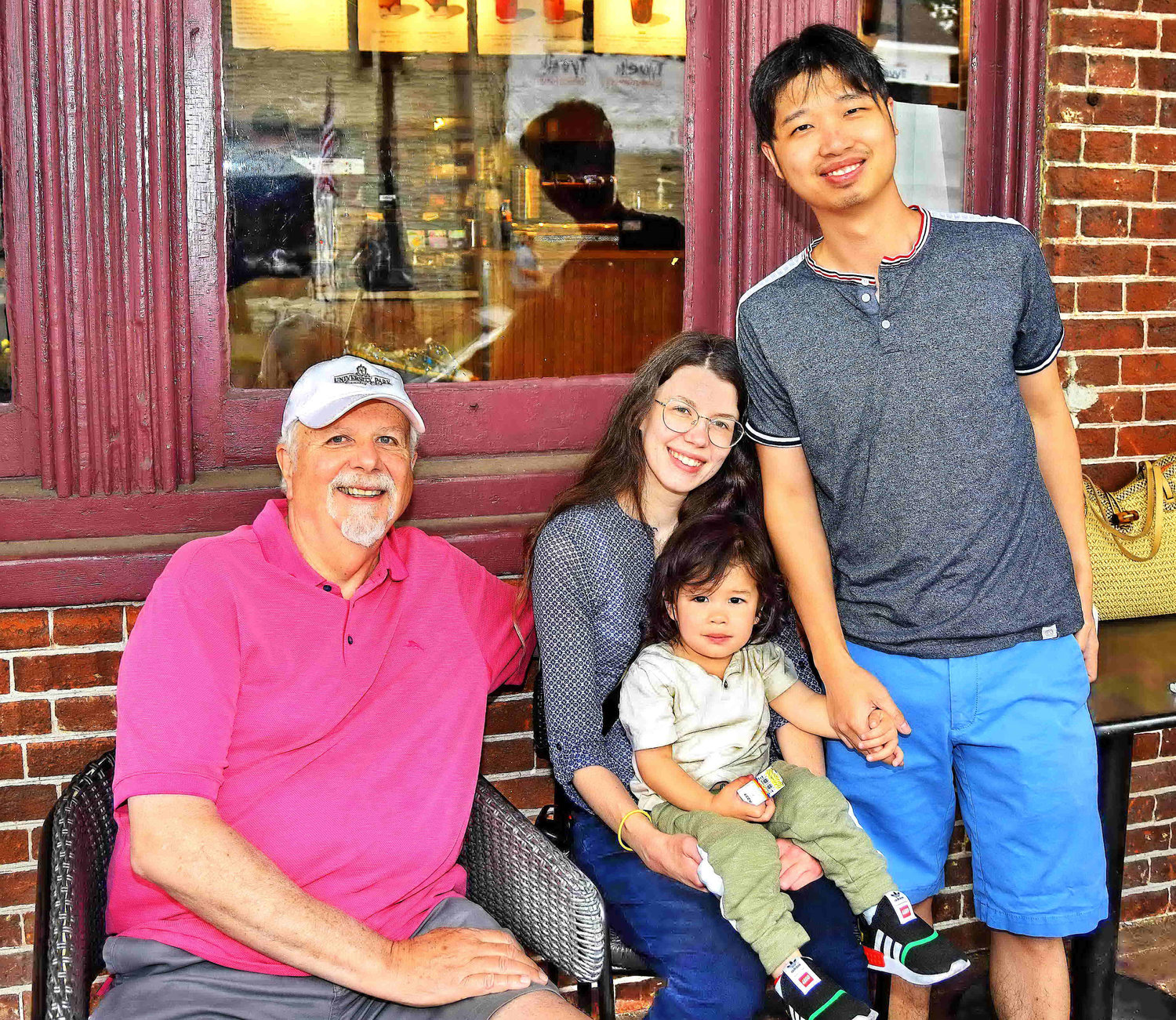 The Li family found an ideal viewing spot at Starbucks.
