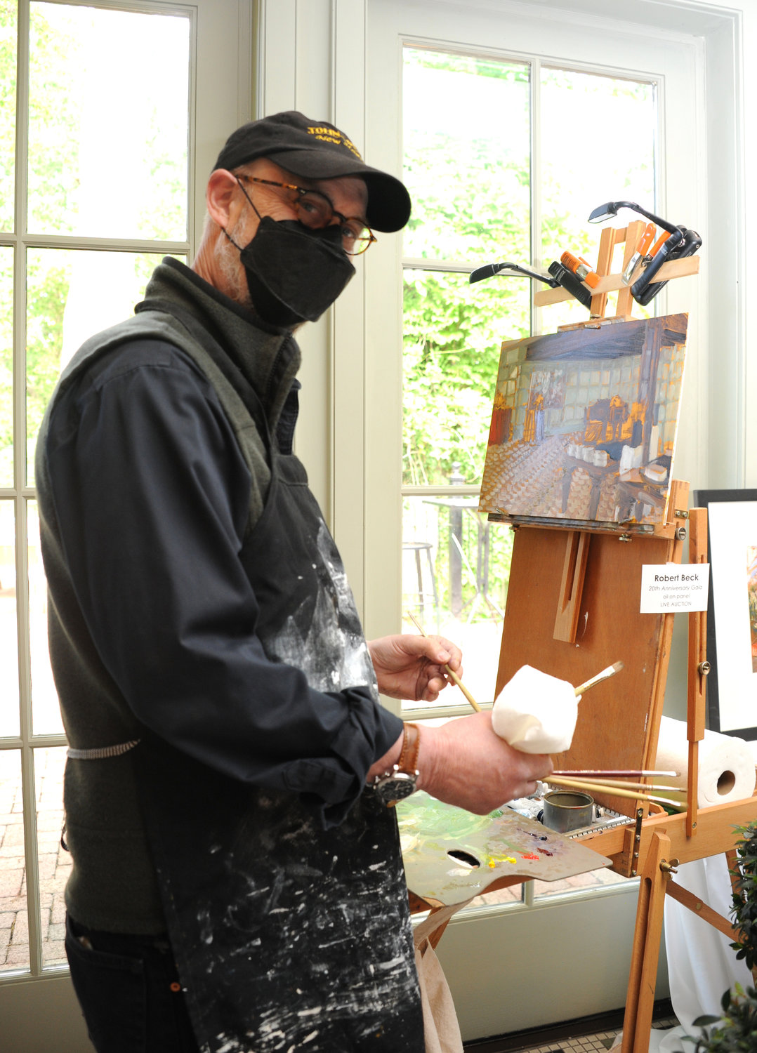 Robert Beck paints an art piece to be auctioned off for the event.