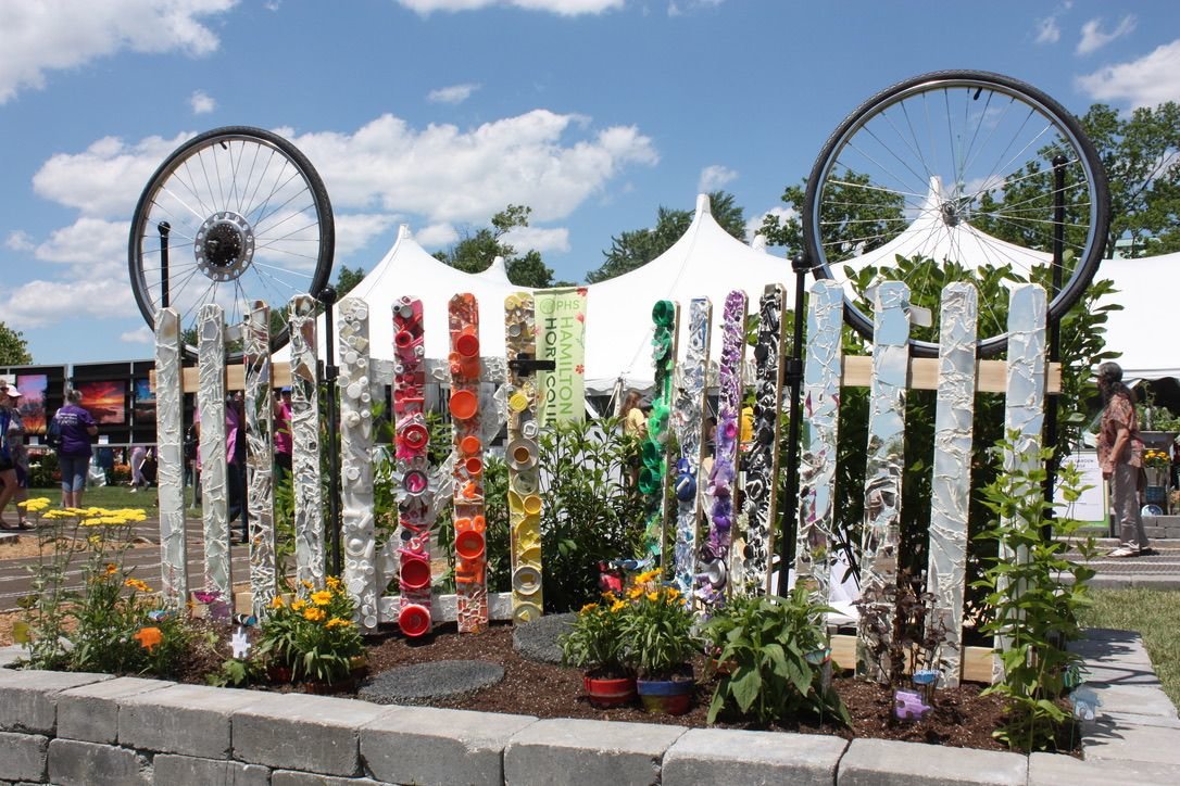 A fence is decorated to impress.