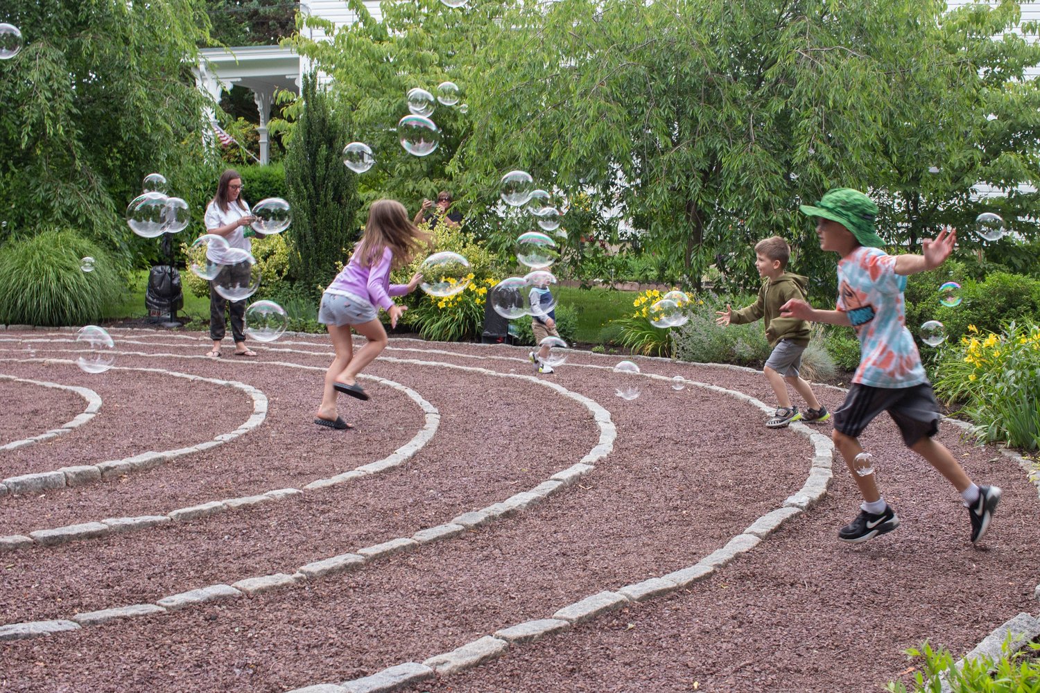 Youngsters do their best to pop bubbles created by “Bubble Witch” Lindsey Noel on the labyrinth.