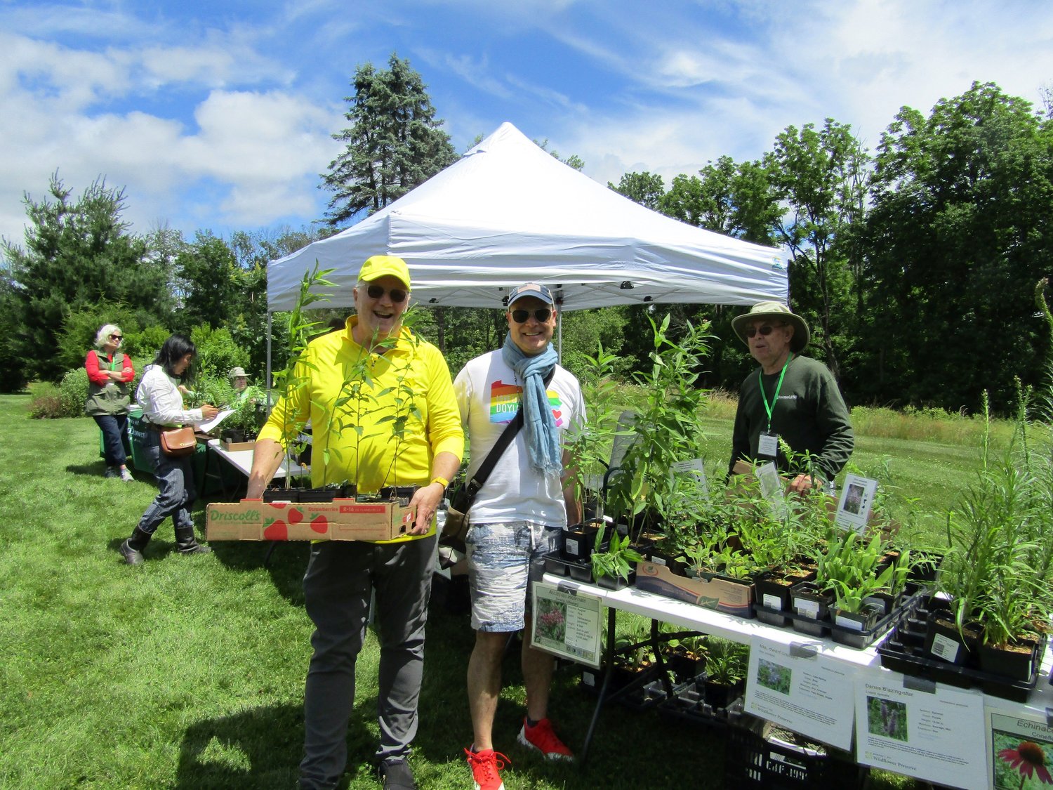 Michael Flanagan and William Hughes purchase native plants from Dave Horne, a Preserve volunteer.