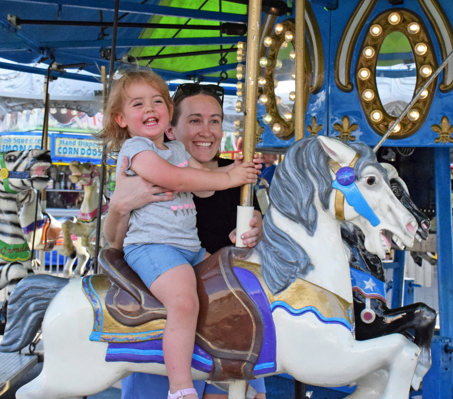 Kristy Wack and her daughter, Payton, 2, of Sellersville ride the carousel.