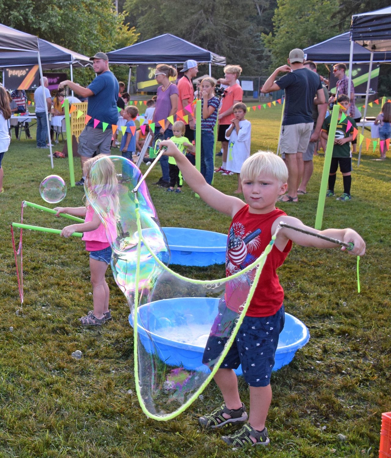 Sawyer Gallo enjoys the large bubbles at the Revival’s Play area.