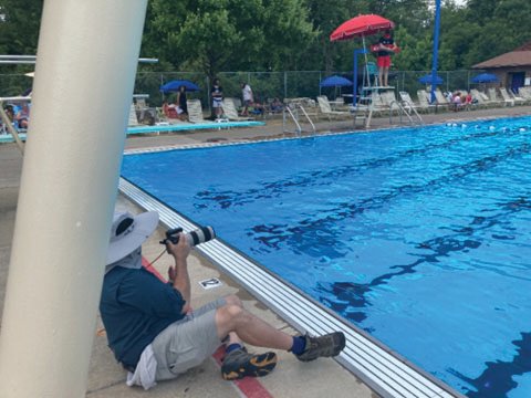 Local photographer Tony Stewart gets ready to take a picture of Lower Makefield Township Assistant Pools Manager Josh Cohen demonstrating a proper lifeguard rescue jump.