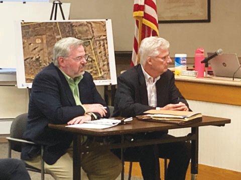 Engineer Gregory Glitzer, left, and attorney Ed Murphy listen as the Buckingham board of supervisors approves a major project for their client, Buckingham Friends School.