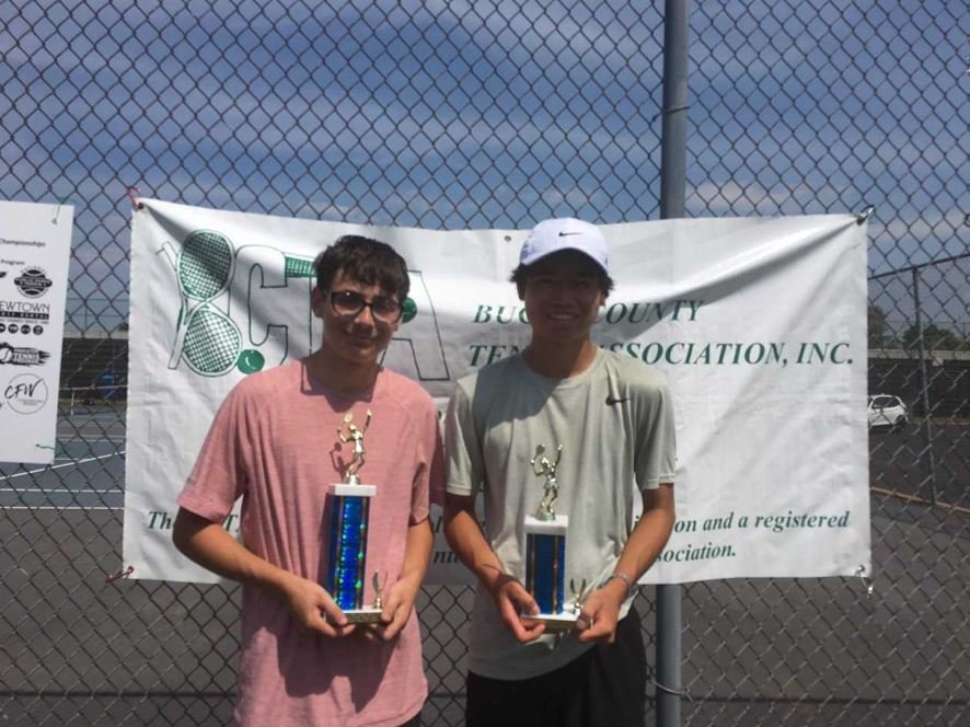 Quakertown's Max Arkans holds his trophy alongside finalist Leo Shi at the National Public Parks Tennis Championship.