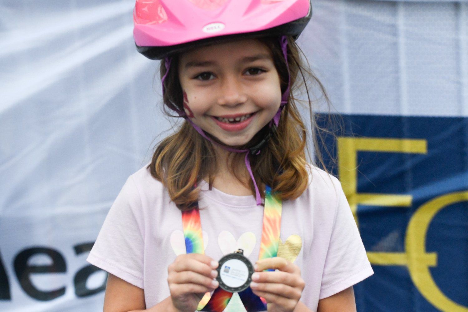 Children’s bike race participant Harper Siedle, 5, of Doylestown shows off her medal.
