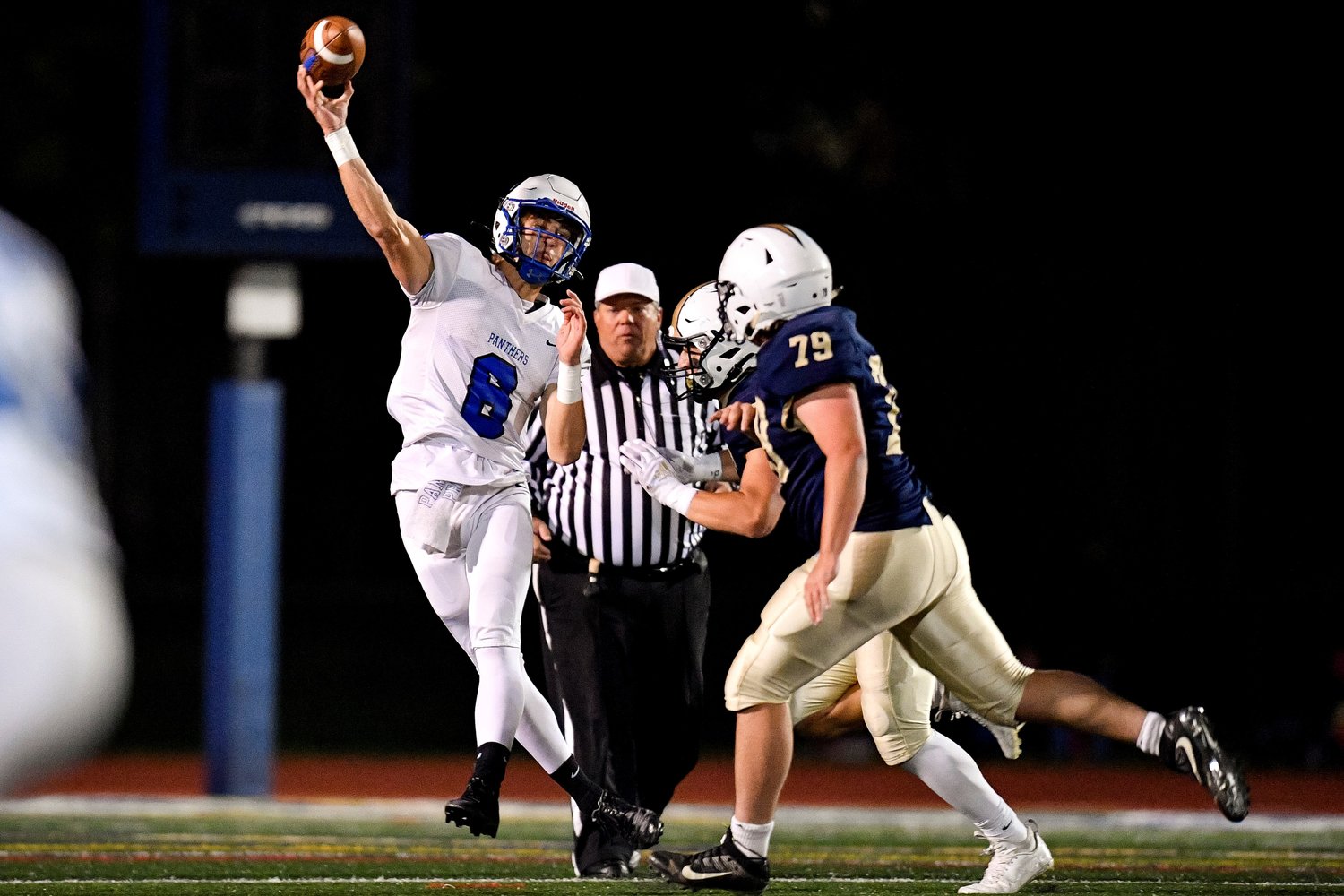 Quakertown QB Vince Micucci launches a long pass as CR South’s Anthony Carey and Jim St. Thomas close in.