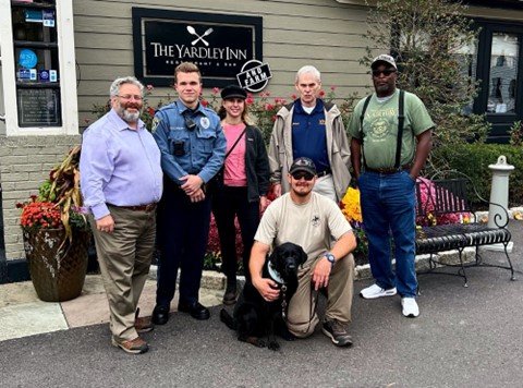 Army veteran Kevin Wilson with his service dog Calvin (front) with (back, from left) Yardley Borough council member David Appelbaum, borough police officer Jake Kulchinsky, Sept. 11 Memorial Trail board member Cindy Kunnas, and local veterans Elliot Neri and Michael Lee.