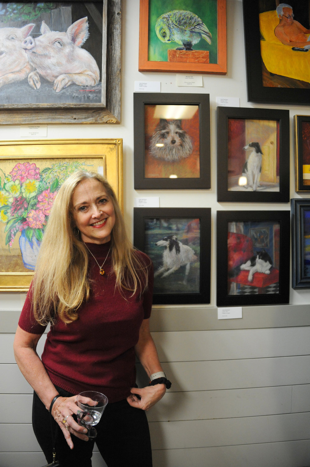 Lisa Harrison next to her group of paintings.