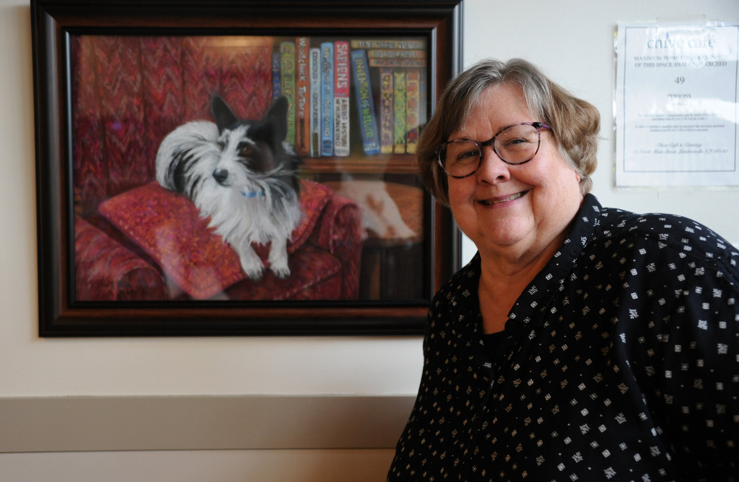 The group’s instructor Pam Miller next to her painting of Badger, “A Scholar and a Gentleman.”
