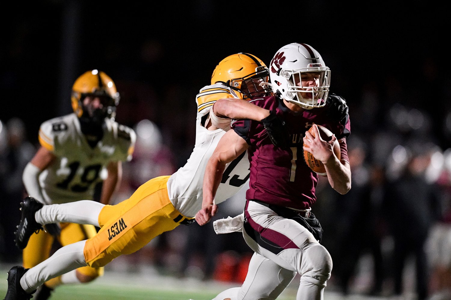 CB West’s Sean Blue leaps on the back of Garnet Valley’s Matthew Mesaros after a long quarterback scramble.