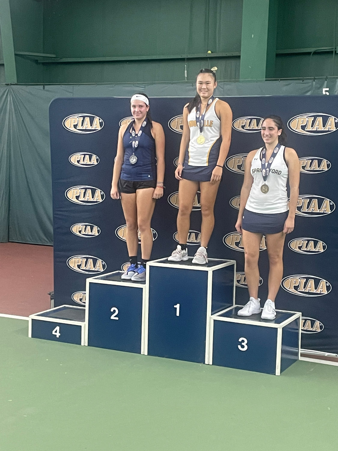 Council Rock South junior Dasha Chichkina, left, earned second-place medals in District One and PIAA Class 3A individual tennis tournaments this fall for the Golden Hawks. Here, she stands on the PIAA podium at Hershey Racquet Club alongside Unionville junior Grace Li, center, and Spring-Ford junior Mia Matriccino, right.