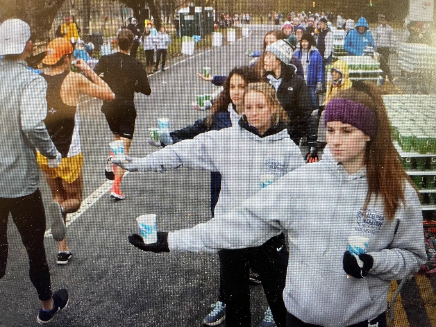 Volunteers from the Delaware County Road Runners Club hand out water at the Philadelphia Marathon.