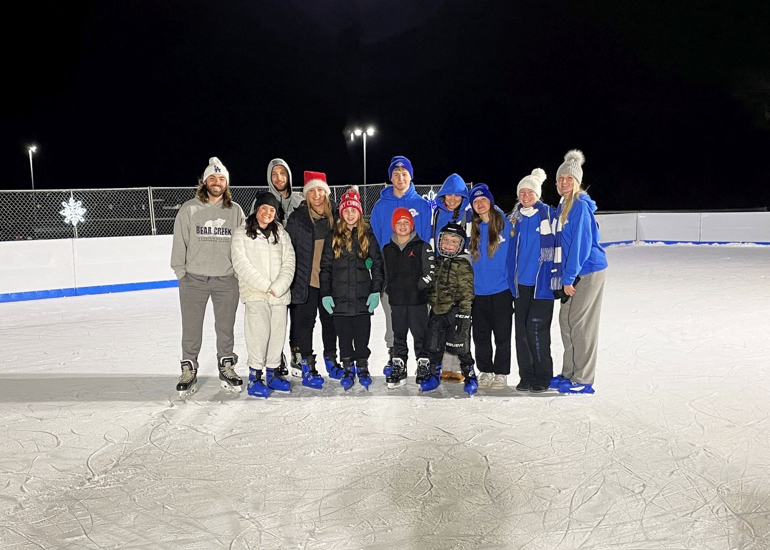 The first group of outdoor ice skaters poses for a photo at the new Flight on Ice Neshaminy Mall outdoor rink.