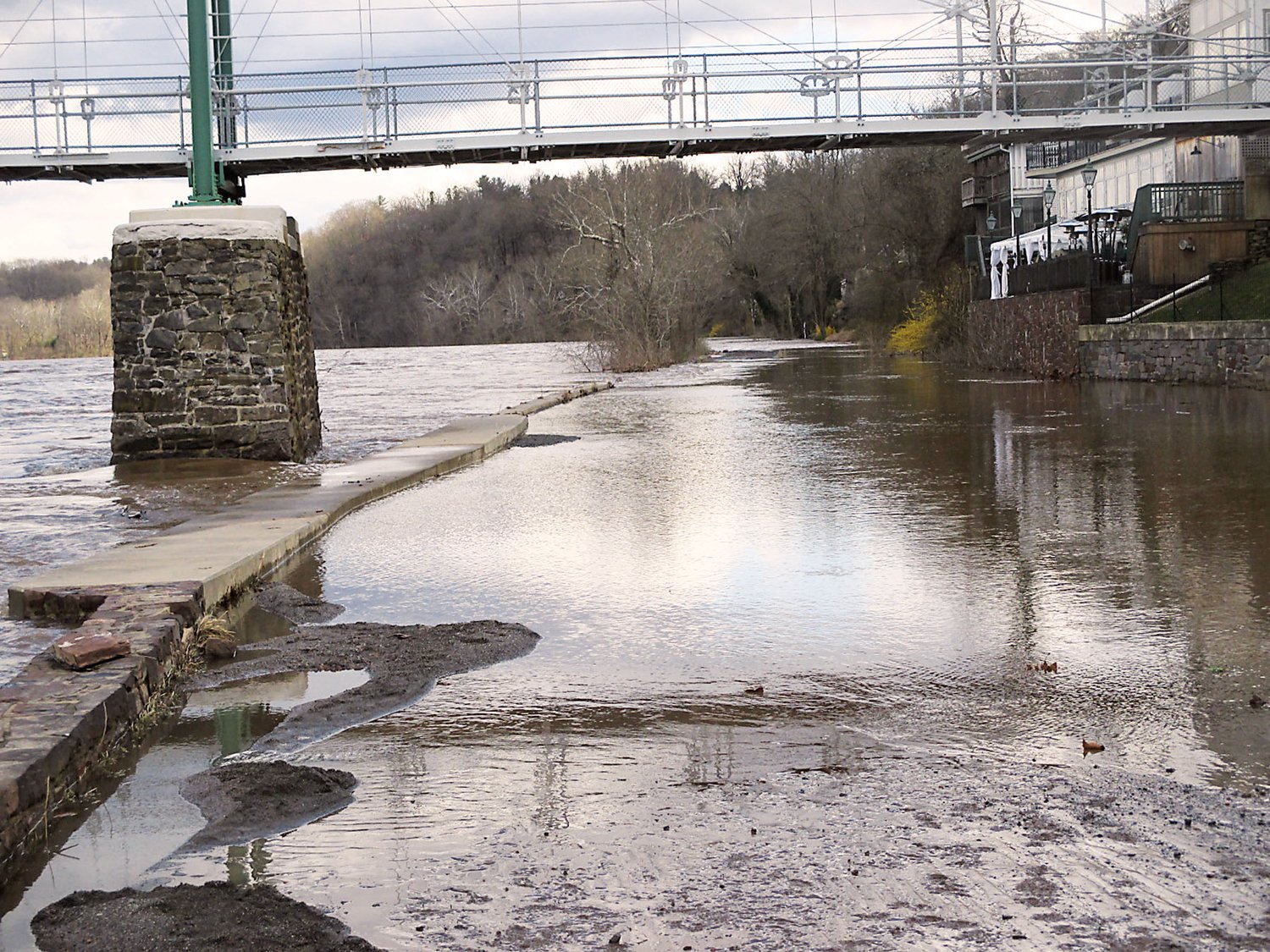 The canal path beside the Black Bass in Lumberville is under water, after the Delaware River is seen rising over its banks there.