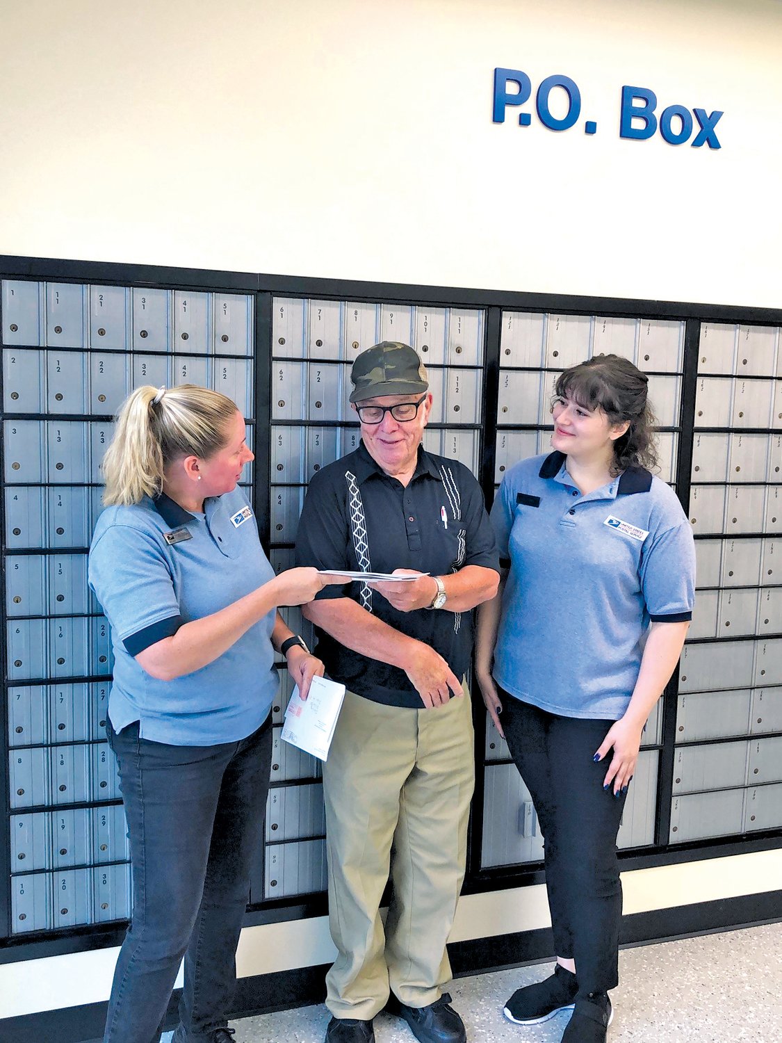 United States Postal Service clerks Melissa Rittenhouse and Amy Brandt greet Dublin resident Terry Gray at the new Dublin Post Office, located at 301 Station Drive.