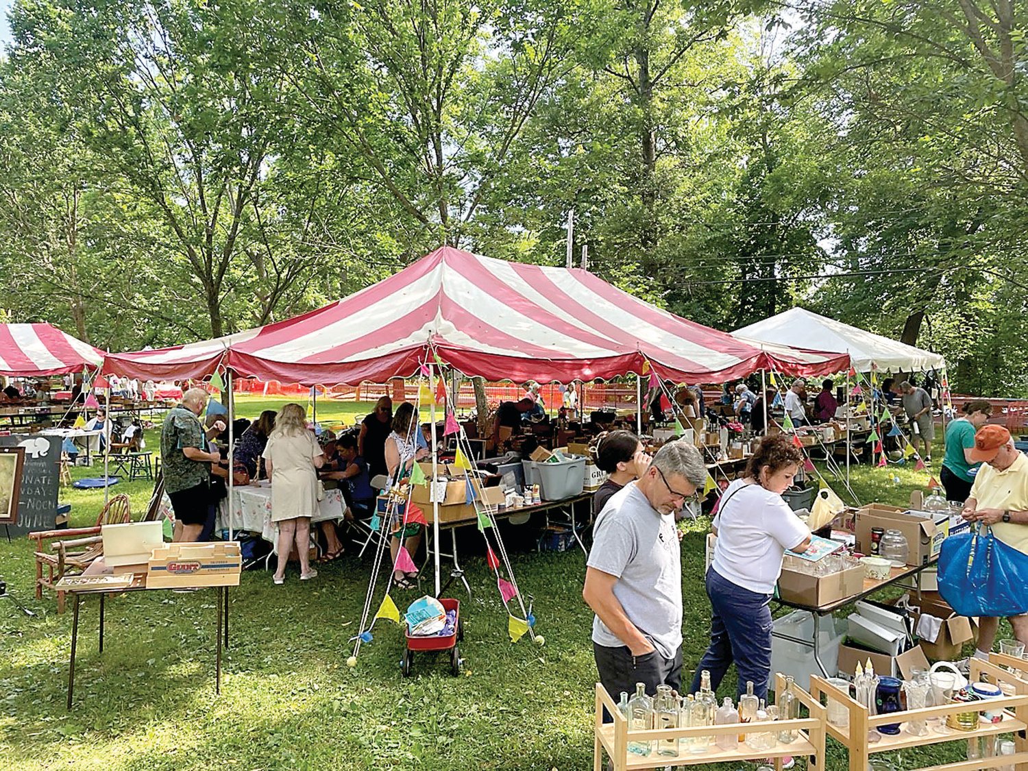 After a two-year hiatus, the Tinicum Arts Festival, presented by the Tinicum Civic Association, returns with record attendance and robust vendor sales. Here, shoppers browse the white elephant tent sale.