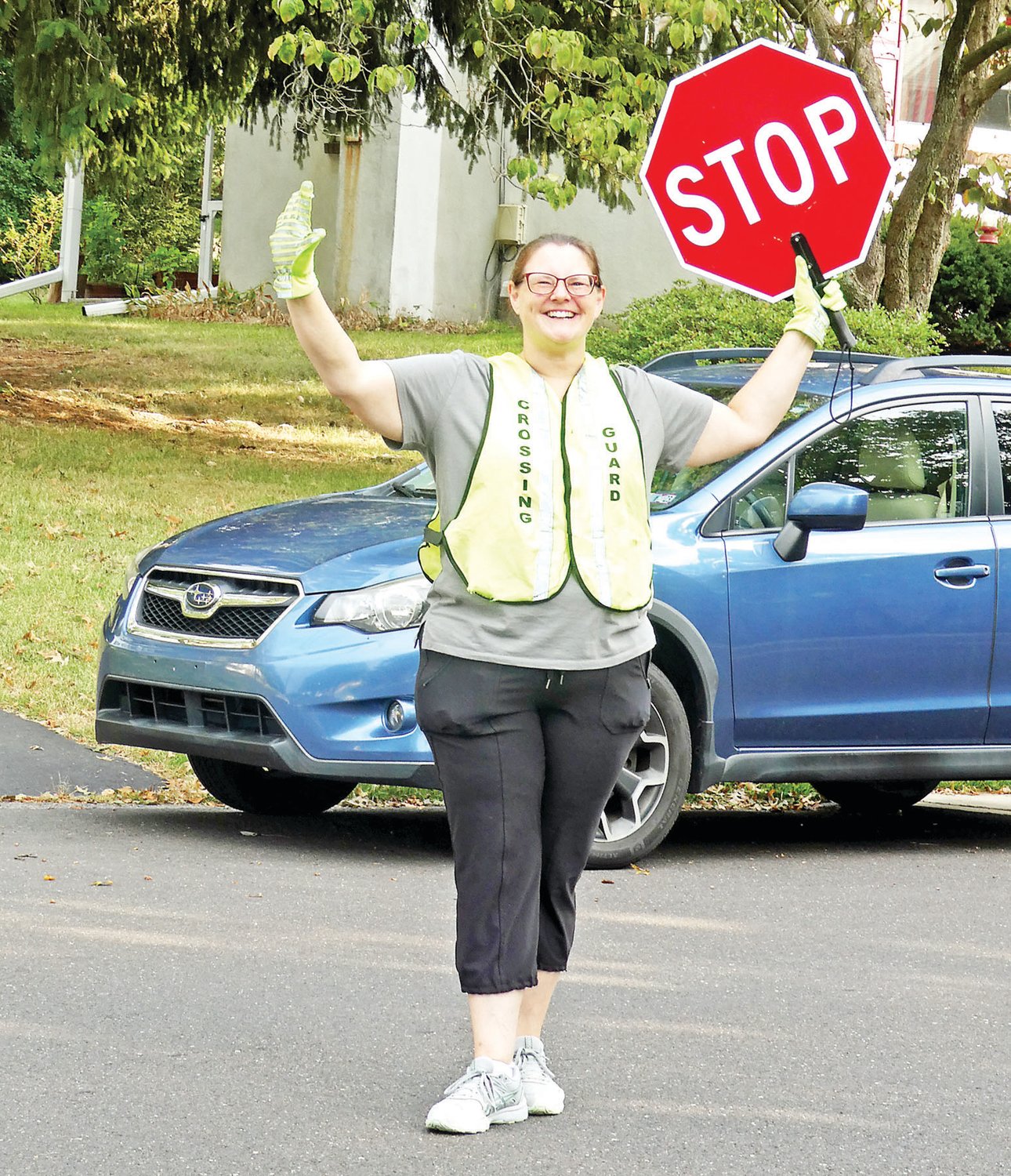 Melisa Baranek, crossing guard, stops cars with a smile at Guth Elementary School in the Pennridge School District on opening day for in-person classes in the 2022-23 school year.