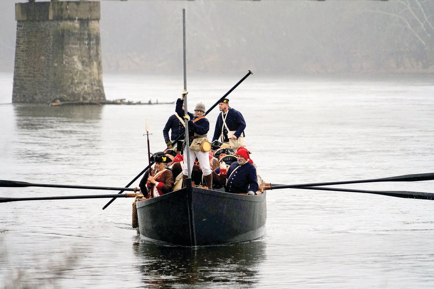 Reenactors row across the Delaware River in a Durham boat. Each December, thousands gather on the banks of the Delaware River to watch the reenactment of George Washington’s daring 1776 Christmas Night river crossing.