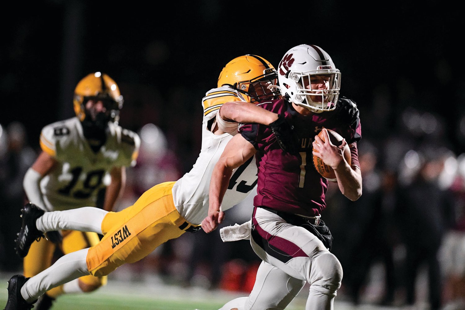 CB West’s Sean Blue leaps on the back of Garnet Valley’s Matthew Mesaros after a long quarterback scramble during the District One 6A final. Garnet Valley defeated the Bucks 35-7.