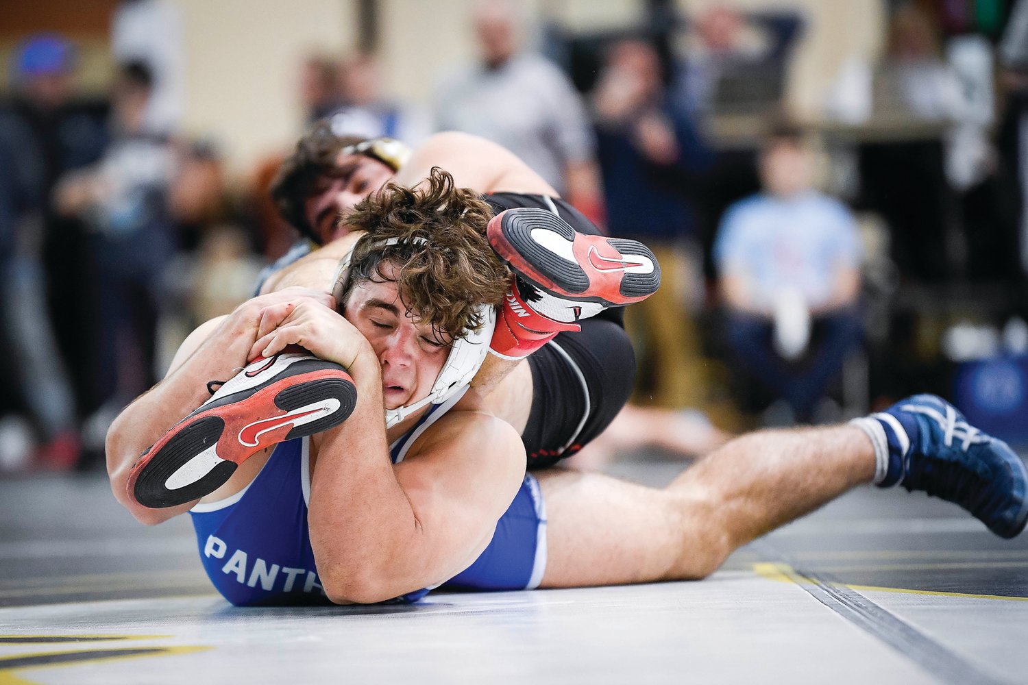 Quakertown’s Calvin Lachman gets a hold of Mt. Olive’s Anthony Moscatello’s foot during his 215-pound semifinal 2-1 decision loss.