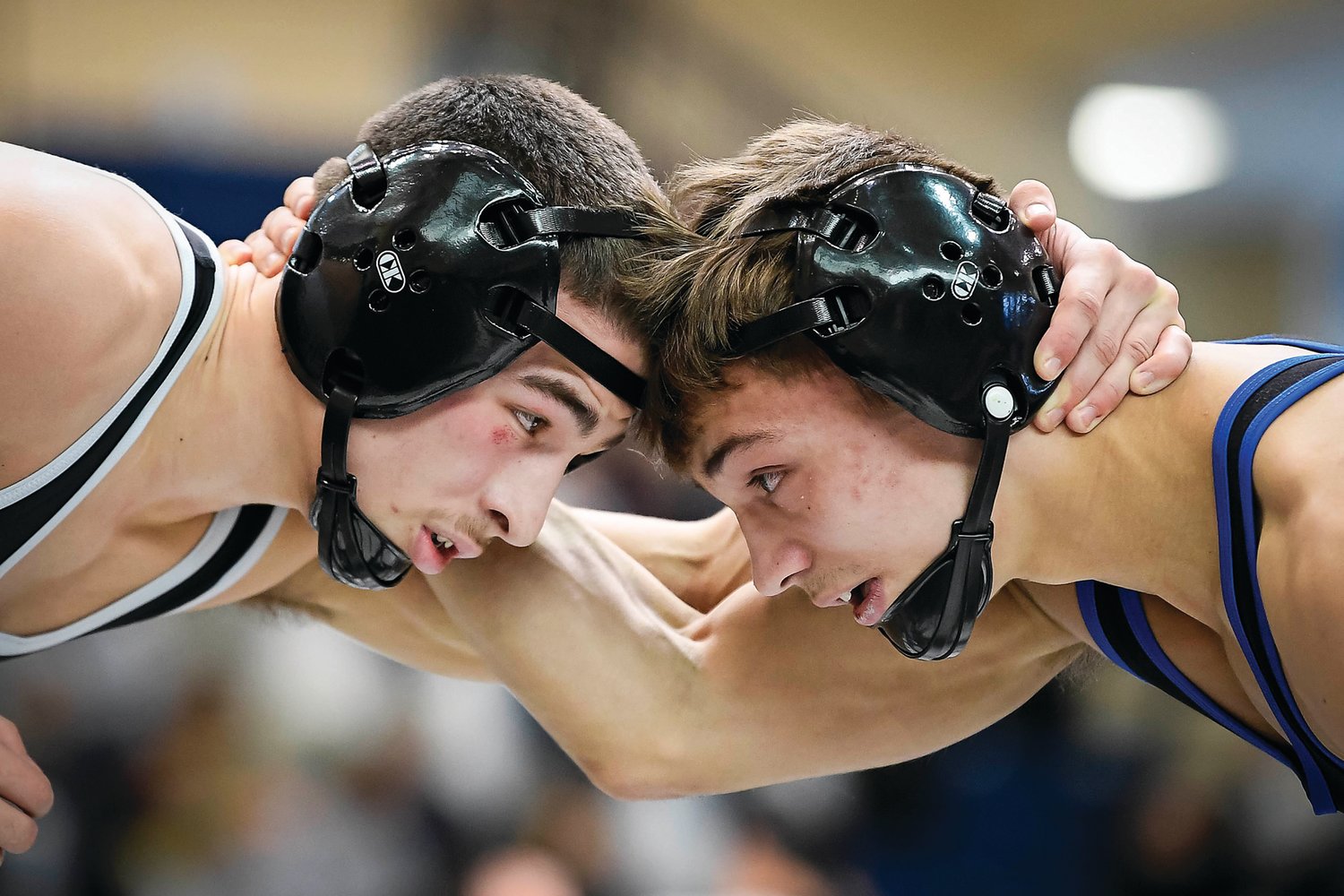 Faith Christian Academy’s Gauge Botero and Quakertown’s Mason Ziegler butt heads during the 121-pound semifinal match won by Botero on a 2-1 decision.