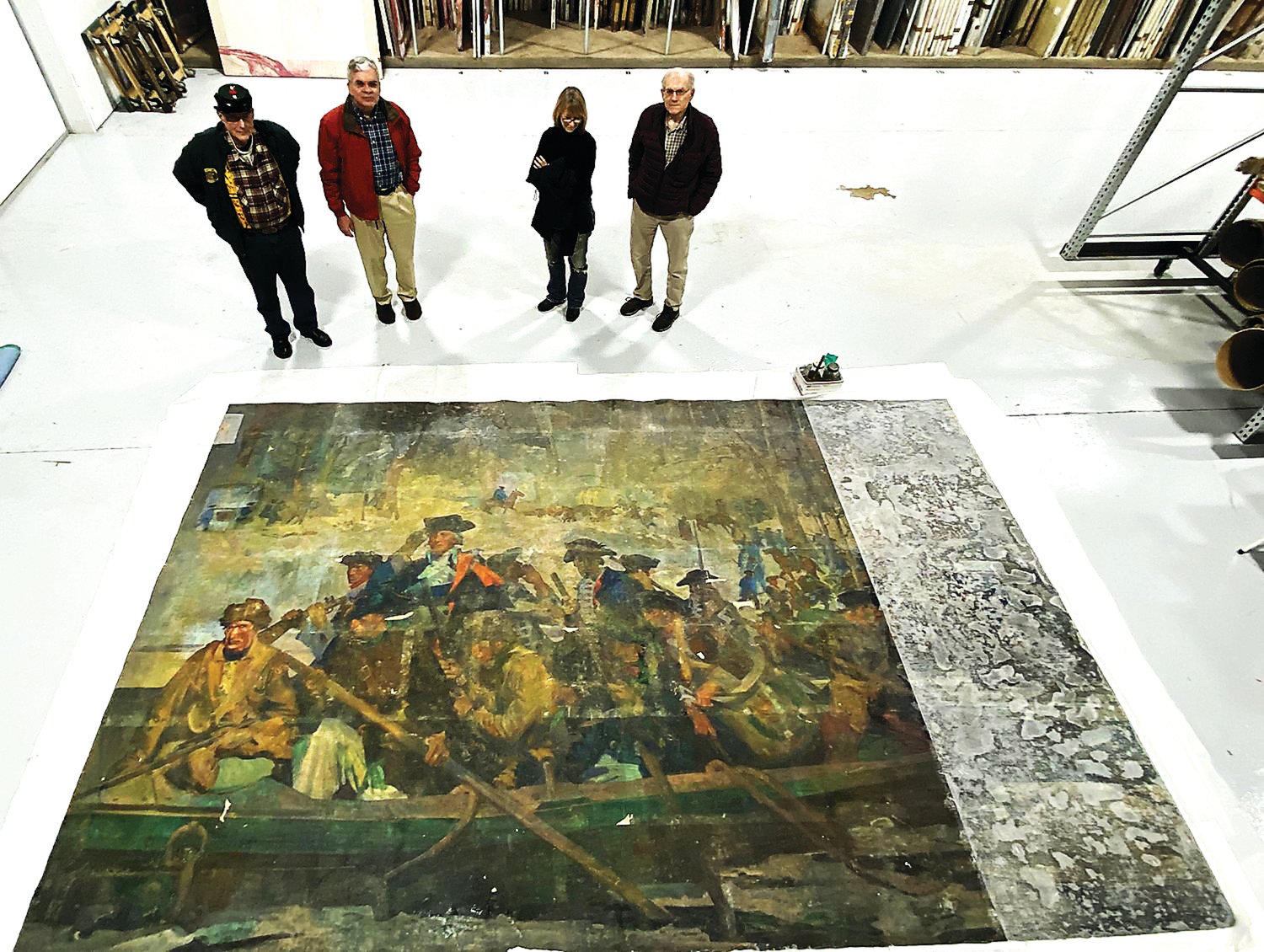 The recently rediscovered 15-foot, 6-inch by 9-foot, 8-inch mural by American muralist George Matthews Harding is in the care of conservator Christyl Cusworth, second from right, with Washington Crossing Park Association trustees.