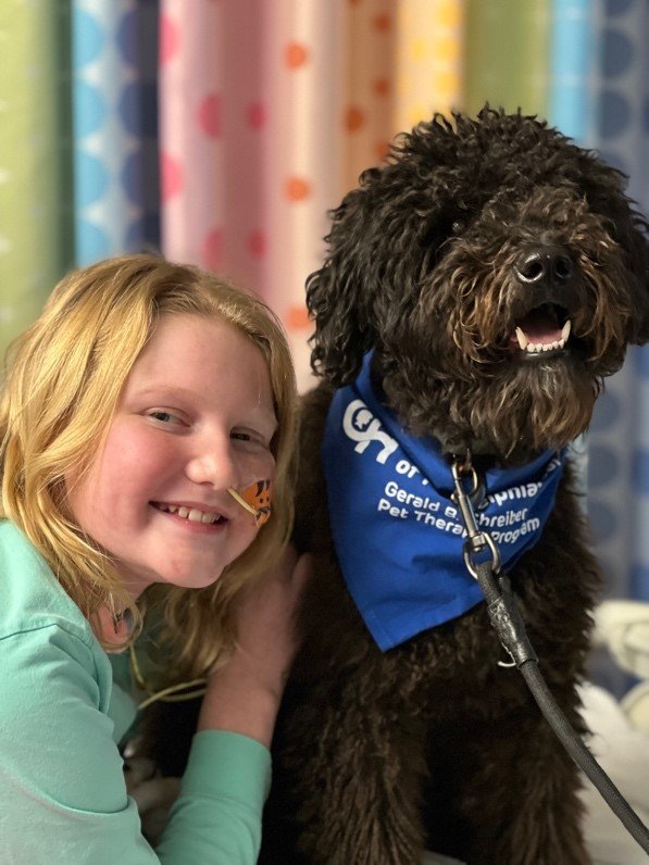 CONTRIBUTED PHOTO
Lily Meade poses for a photograph with a therapy dog that visited with her at Children’s Hospital of Philadelphia. She said the first thing she wanted to do upon returning to her Warrington home on Feb. 2 was see her own dog Sophie.